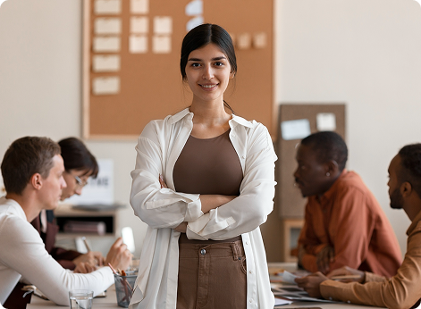 Young woman with folded arms smiles confidently
