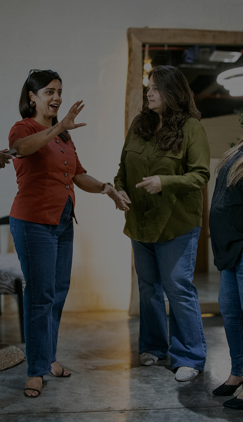 Two women standing together and conversing
